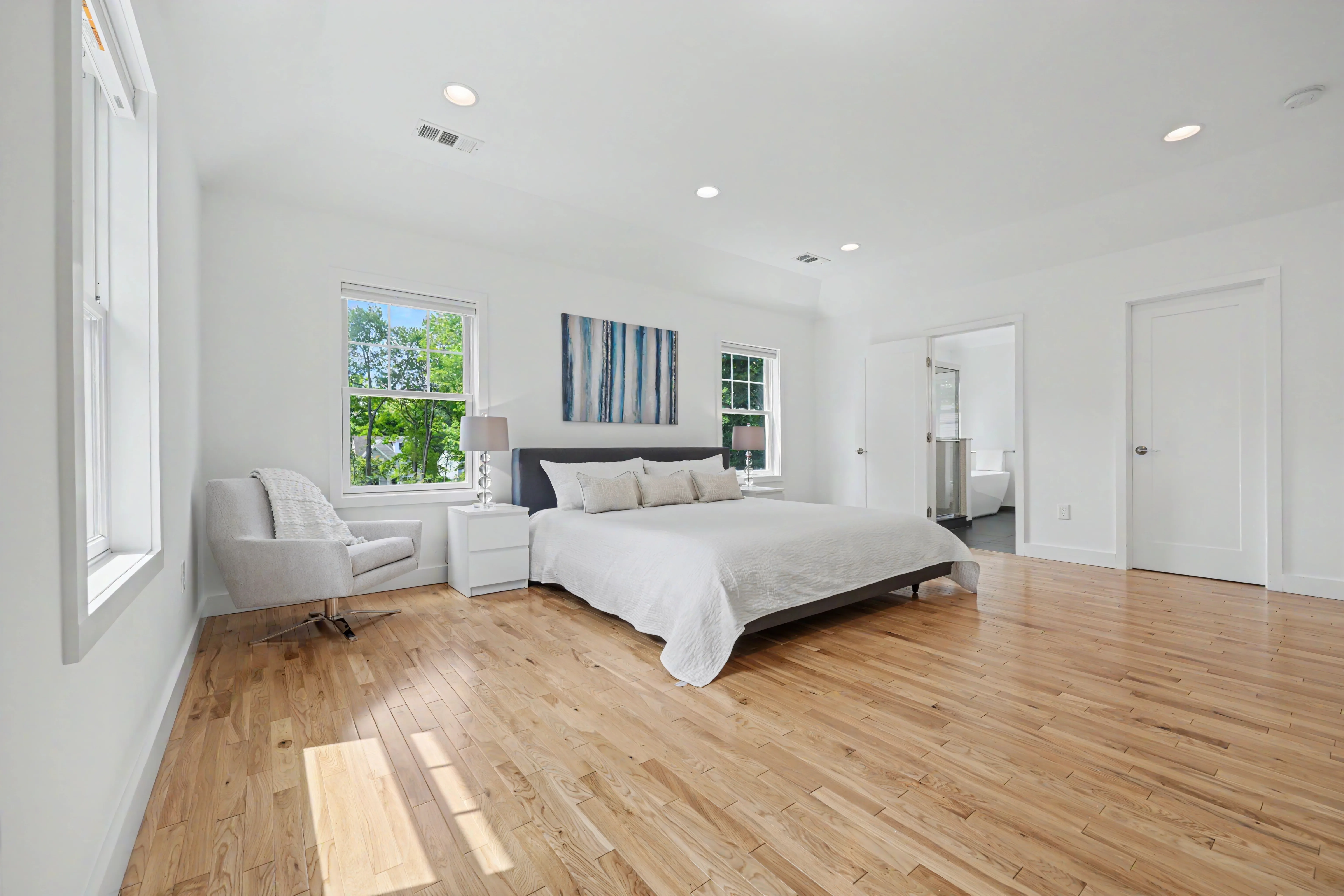 Spacious primary bedroom with natural light and hardwood floors — real estate listing photography, Westchester County NY