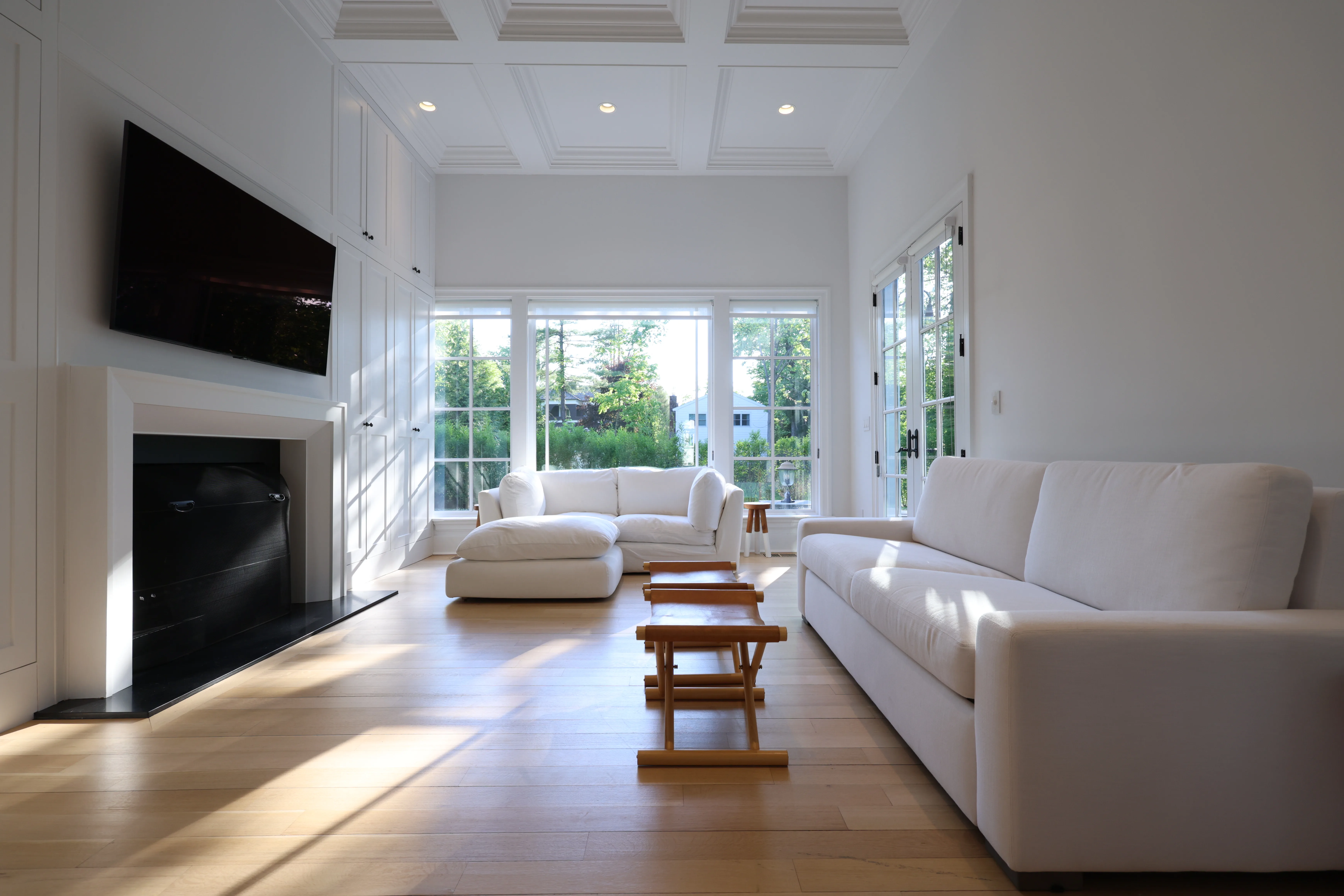 Living room as shot — TV glare visible, fireplace unlit, before post-production