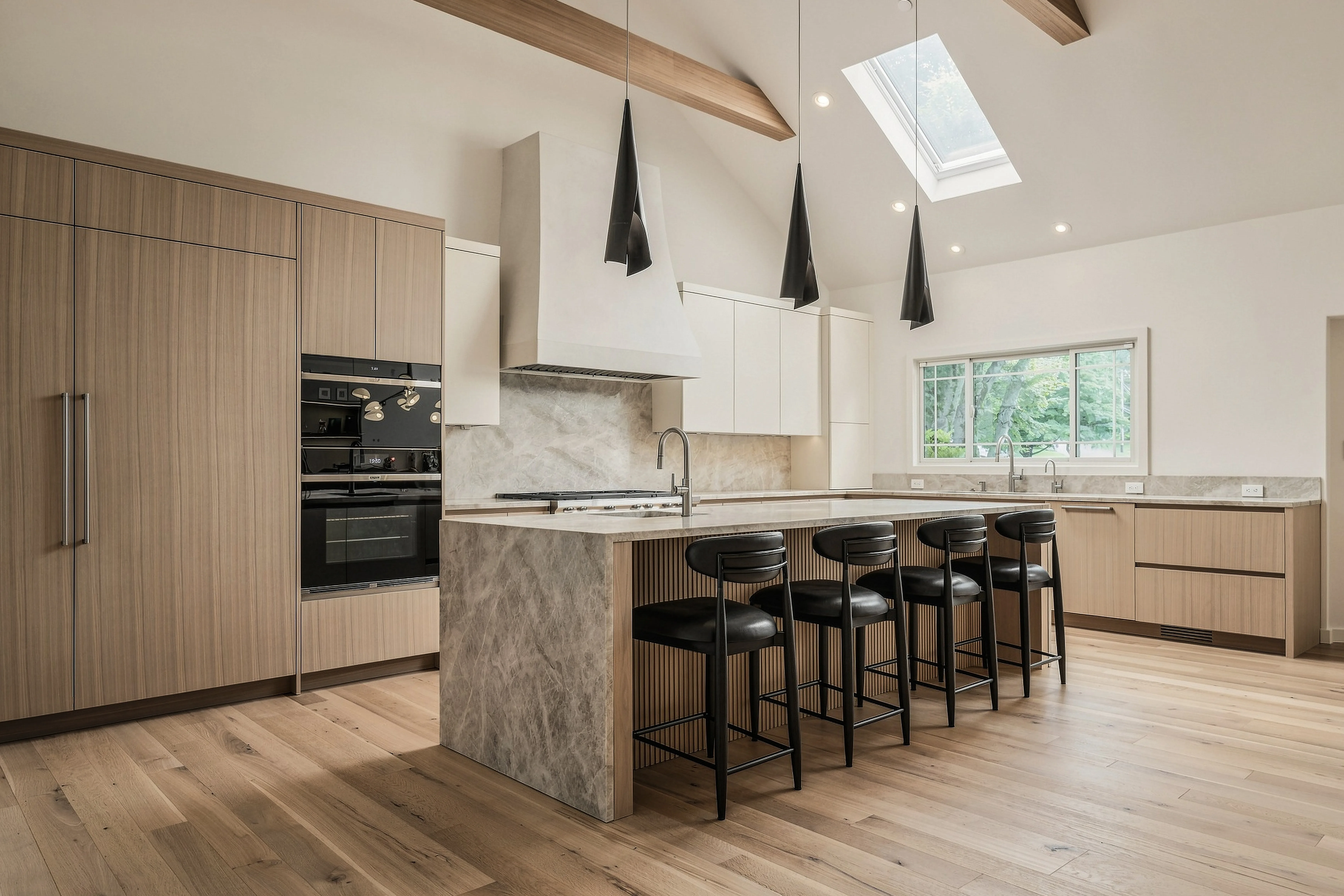 Same vaulted kitchen with waterfall marble island, black bar stools, and skylight — after premium cinematic editing